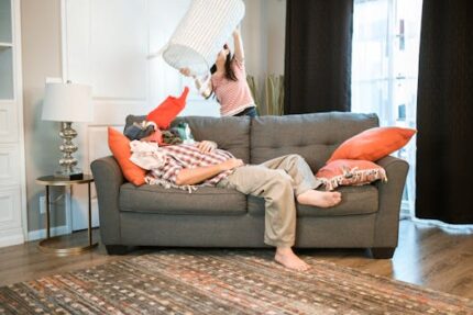 A couple having fun at home with playful activities on a cozy sofa in the living room.